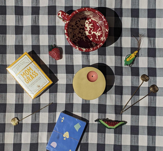 a gingham tabletop with ceramics on top