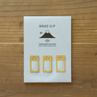 Brass airplane clip set on paper card, three small clips with airplane cutouts