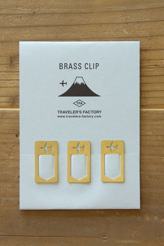 Brass airplane clip set on paper card, three small clips with airplane cutouts