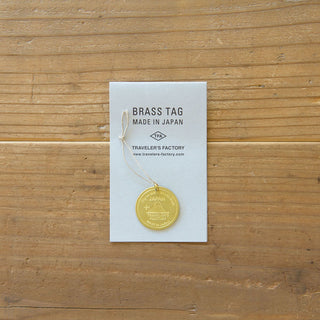 Brass tag bookmark on paper card, engraved “TRAVELER’S FACTORY,” made in Japan