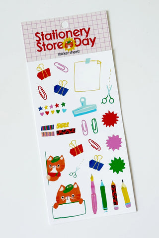 Cat cashier sticker sheet with colorful stationery icons, pens, scissors, and notepad