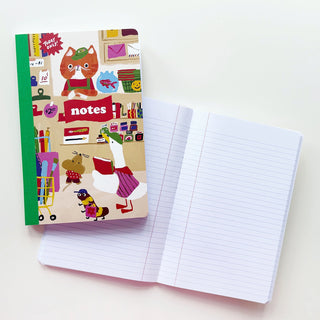 Composition notebook with colorful illustrated cover and open ruled pages