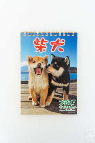 Desk calendar with Shiba Inu pair cover, year 2027, spiral rings binding.