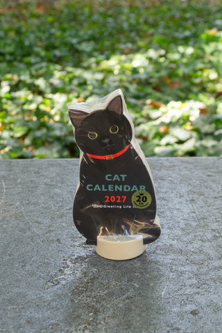 Cat die-cut calendar with black cat cutout and clear base stand, 2027 text