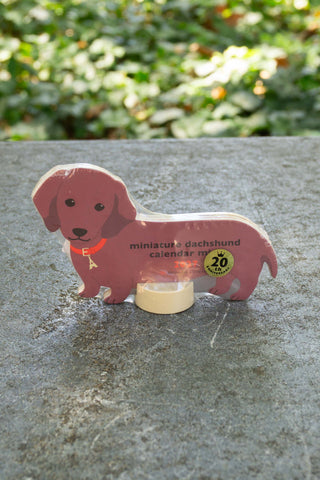 Mini dachshund die-cut calendar with clear stand and badge showing 20