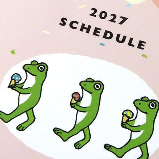 Close-up of A6 monthly planner 2027 schedule cover with green frog characters