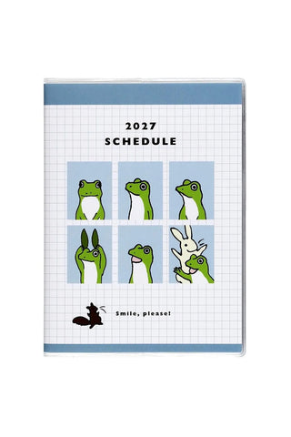 A6 monthly planner cover with blue header, frog icons, and 2027 schedule text