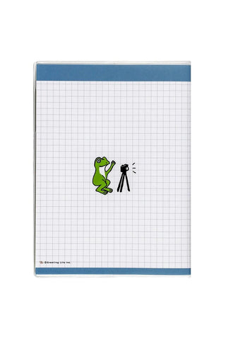 A6 monthly planner cover with light grid background, green frog illustration, blue trim