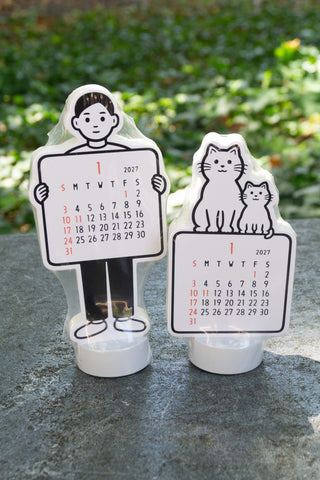Noritake 2027 stand calendars, boy and cat figures with monthly date boards