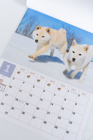 Shiba Inu wall calendar page with two Shiba Inu dogs in snow