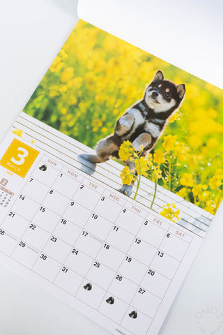Shiba Inu wall calendar page with dog sitting by yellow flowers