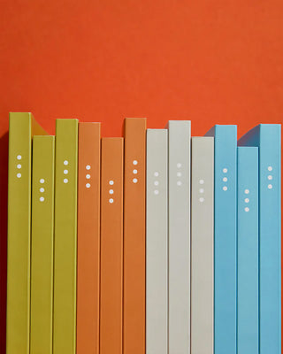 Row of 3-month goal planner covers in green, olive, orange, white, and blue