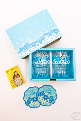 Blue floral stacking glass set in open box with two cups and coaster plates