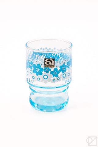 Single blue floral retro stacking glass cup with coaster base and logo label