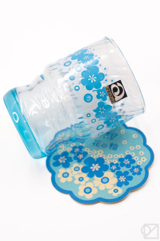 Blue floral retro stacking glass cup tipped forward with matching cloud-shaped coaster