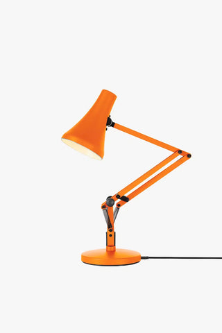 Sunburnt orange mini desk lamp with angled shade and adjustable metal arms