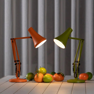 Sunburnt orange mini desk lamp with lit white shade and jointed articulated arm