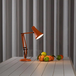 Sunburnt orange mini desk lamp with upward shade and round base