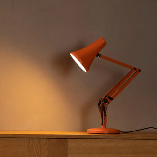 Sunburnt orange mini desk lamp with angled shade and arched articulated stand