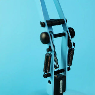 Turquoise Anglepoise mini desk lamp mechanism with springs and black controls