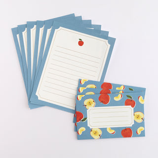 Stack of blue apple letter cards with lined writing areas, plus one fruit-pattern card