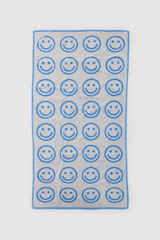 Sky blue bath towel with repeating smiley faces in blue outline print