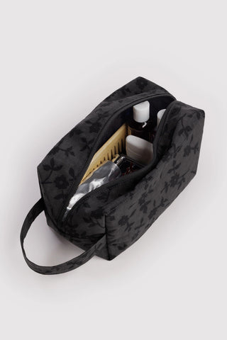 Charcoal floral toiletry bag with open interior and zipper closure