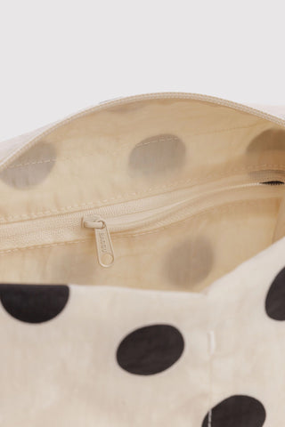 Cream polka dot dopp kit interior with beige lining and zippered pocket