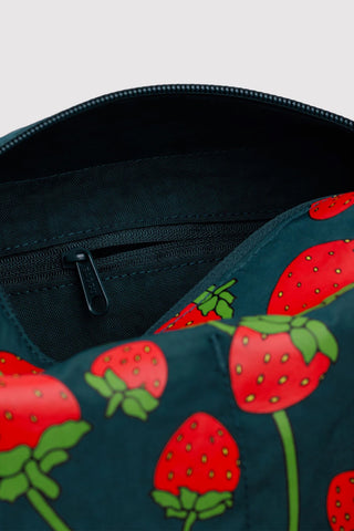 BAGGU dopp kit close-up: strawberry print exterior, dark teal zipper track and inner panel.