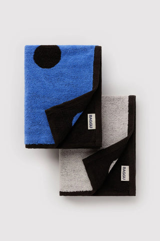 BAGGU polka dot hand towel set of 2, folded: blue towel and dark towel with white dots.