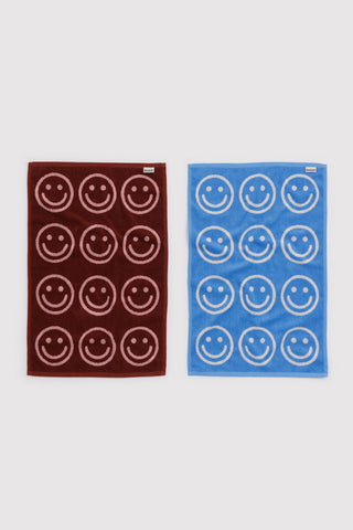 Set of 2 hand towels, blush pink and sky blue with circular smiley face pattern