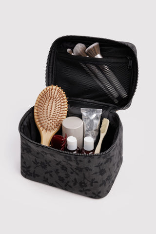 Large cosmetic case open in charcoal ditsy floral, black lining with mesh organizer pockets
