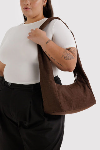 Coffee-brown nylon shoulder tote bag worn on model, short handles