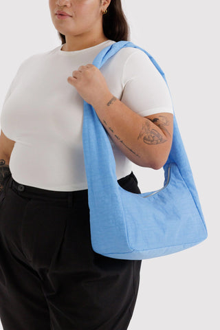 Light blue nylon meringue tote bag worn on shoulder
