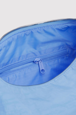 Light blue nylon bag interior with zippered pocket and zipper pull