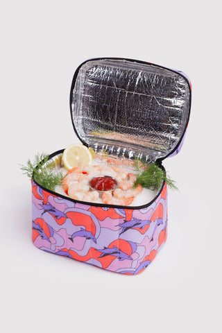 Puffy lunch bag open with reflective foil lining and dolphin print exterior, black trim