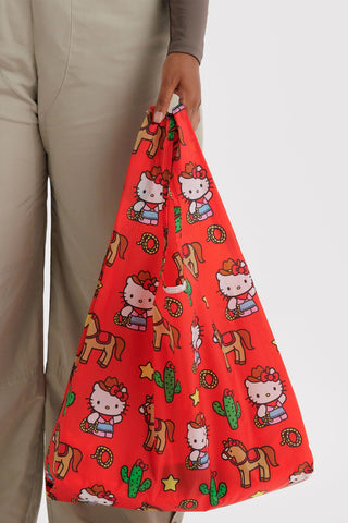 Red Hello Kitty tote bag with cowboy, cactus, and star pattern; long shoulder handles