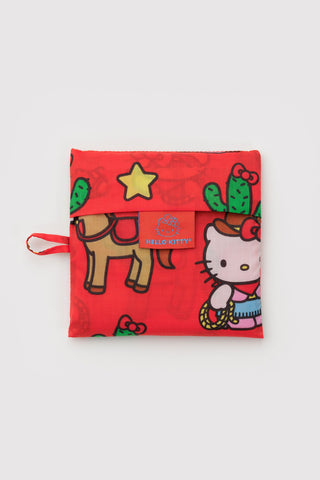 Folded red Hello Kitty western tote pouch with carry loop and cactus, star, horses print
