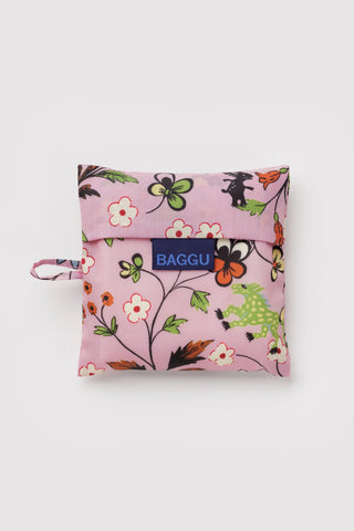 Folded purple floral reusable tote bag with BAGGU logo label