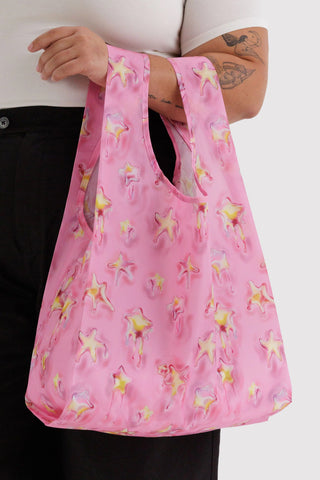 BAGGU standard tote bag, pink Dancing Star print, held by long handles