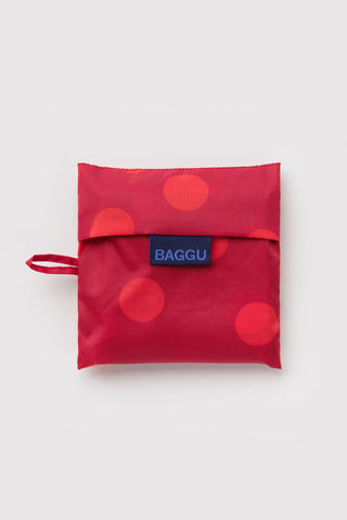 BAGGU reusable tote bag with blue logo patch and red polka dot fabric