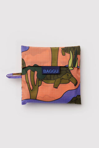 Foldable turtle-print tote pouch with BAGGU logo tab and small loop handle