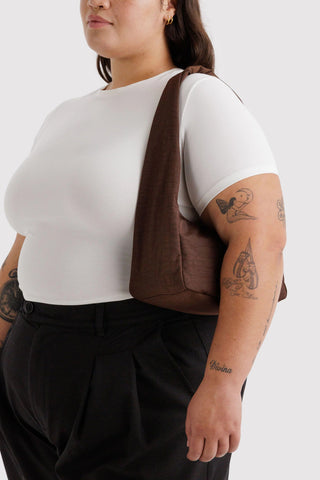 Small nylon shoulder bag in dark coffee-brown, worn on shoulder