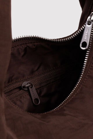 Dark coffee-brown nylon bag interior with zipper and metal zipper pull