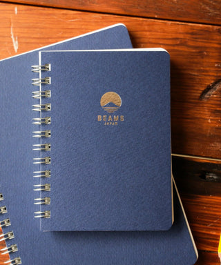 Navy BEAMS Japan lined notebook with metal spiral binding and logo on cover