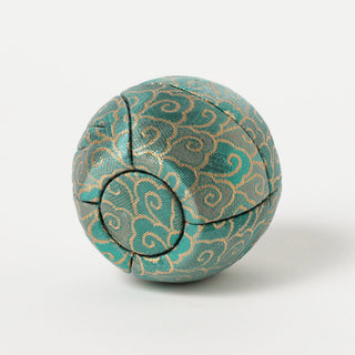 Teal patterned fabric Daruma-style figure viewed from the back