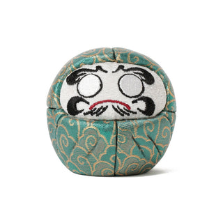 Teal patterned fabric Daruma-style figure with embroidered angry face