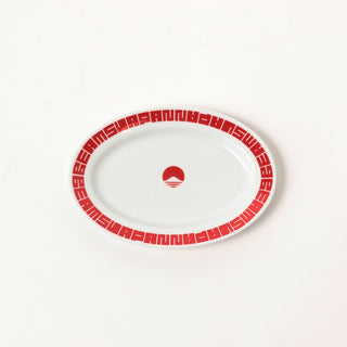 White oval plate with red patterned rim and small red logo at center