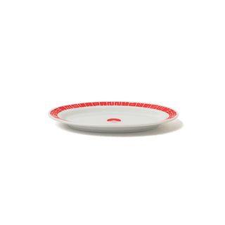 White oval gyoza plate with red patterned rim and red center mark