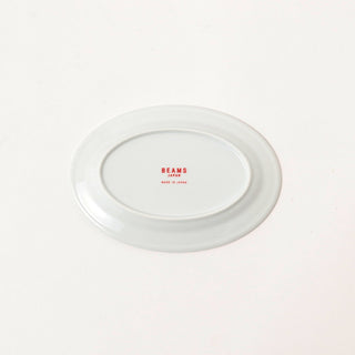 White oval plate bottom with small BEAMS Japan logo centered